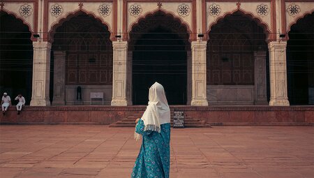 Intrepid traveller stands in awe in the coutyard of the Jama Masjid mosque in Delhi, India