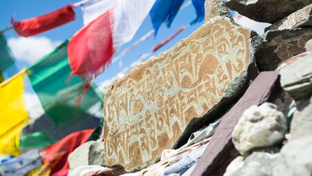 Mani stone with sanskrit prayer inscription at Ganda La Pass on the Markha Valley Trek