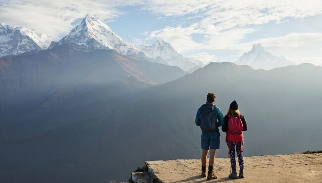 Intrepid travellers hiking in the Annapurna Foothills take in the view of the range from Poon Hill in Nepal