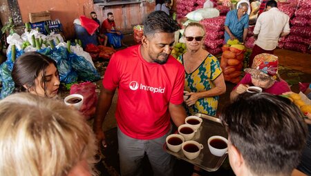 Leader sharing tea at the food market in Dambulla, Sri Lanka