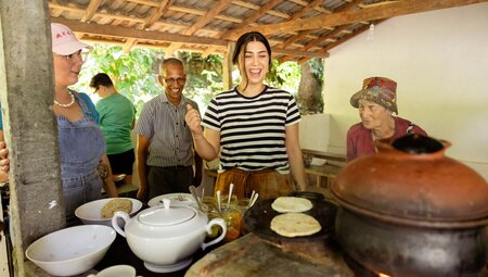Travellers laughing with guide at the spice garden tour in Matale, Sri Lanka