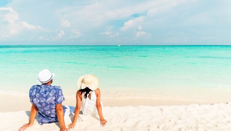 Traveller couple relaxing on a beach in the Maldives