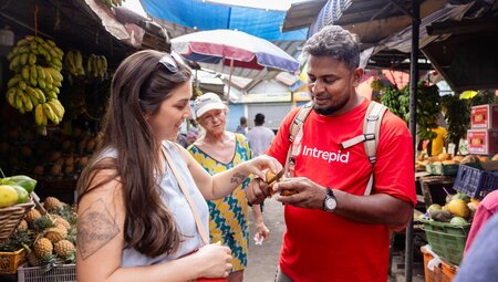 Travellers with guide during market wander and tasting in Kandy, Sri Lanka