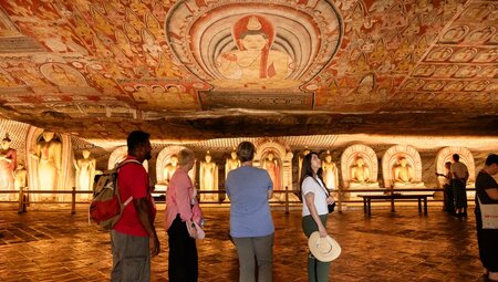 Interior of cave temple with Buddha art on the ceiling in Dambulla, Sri Lanka