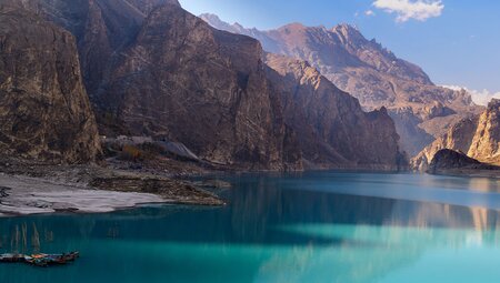 Aqua waters are surrounded by rocky landscape and mountain peaks of Pakistan