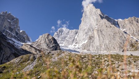 A granite peak of one of Karakoram Mountains towers over the scrub covered Nangma Valley seen on a hike