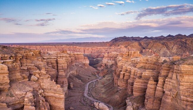 High view of Charyn Canyon's striated pointing sides with a path going down the center in northern Khazakhstan