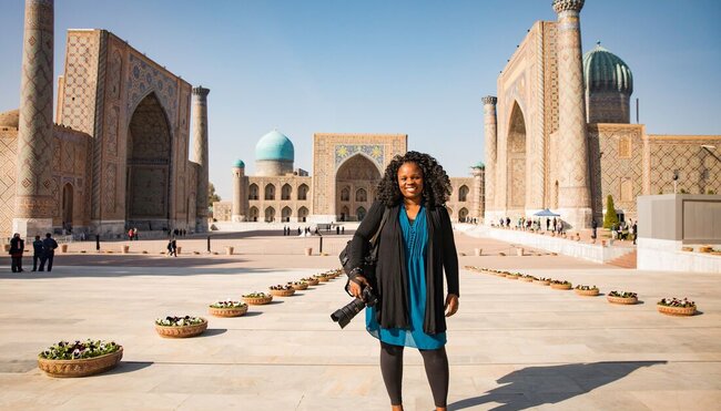 Intrepid traveller poses with camera at the opening of Registan Square in Samarkand, Uzbekistan