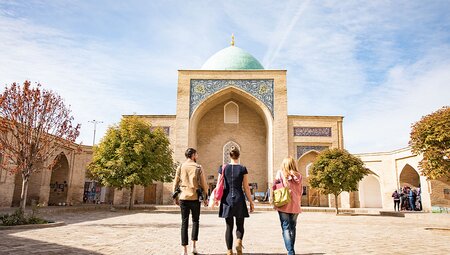 Group of Intrepid travellers approach the Kukeldash Madrasah in Tashkent, Uzbekistan