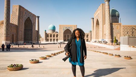 Intrepid traveller poses with camera at the opening of Registan Square in Samarkand, Uzbekistan