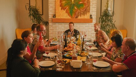 Intrepid travellers and leader enjoy a wine tasting dinner in Khaketi at a winery hotel