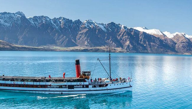 Boat by Queenstown with beautiful mountain backdrop, South Island, New Zealand