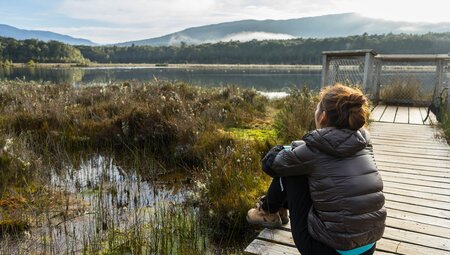 Woman taking in the views at Te Anau, New Zealand