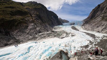 Tourists hiking Franz Josef Glacier in New Zealand