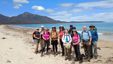 Group of hikers at Wineglass Bay, Tasmania, Australia