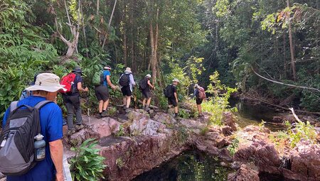 Group hiking through Cascade Falls, Northern Territory, Australia