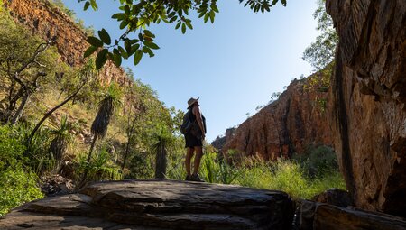 Traveller basks in the beautiful natural surroundings of Emma Gorge in the Kimberley Western Australia