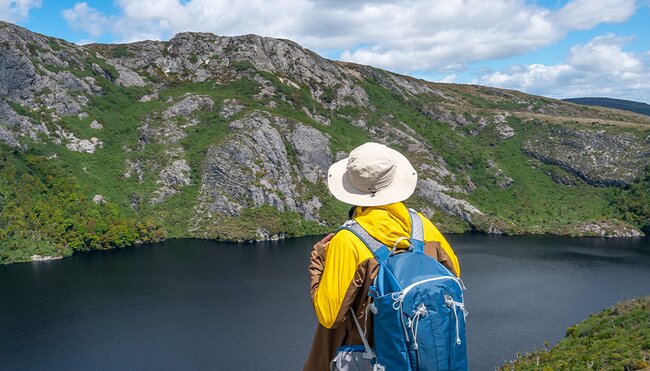 Traveller looking out from Marions Lookout, Cradle Mountain Trek