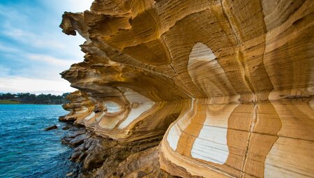Painted cliffside on coast of Maria Island, Australia