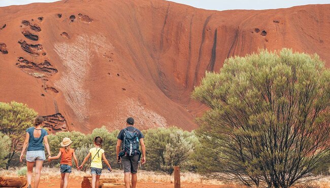 Family hand in hand while walking through the Red Centre, Australian Outback