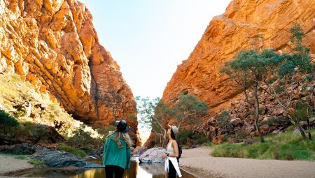 Travellers looking up at Simpsons Gab, Northern Territory, Australia