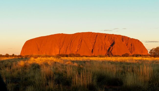 Travellers enjoy view of Uluru sunset