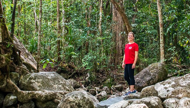 Intrepid leader standing amidst the stones of the Daintree Rainforest