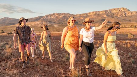 Group and leader walking at sunset in the Flinders Ranges, South Australia