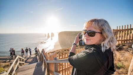 Traveller taking photo of Twelve Apostles, Great Ocean Road, Victoria, Australia