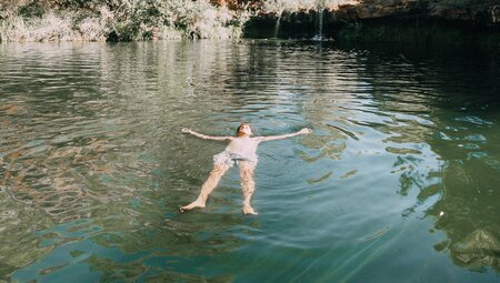Intrepid traveller floating peacefully in a waterhole in Karijini National Park