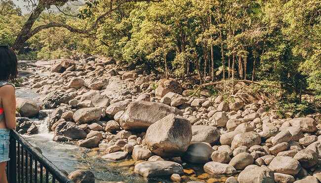 Woman overlooking Mossman gorge national park in far north Queensland