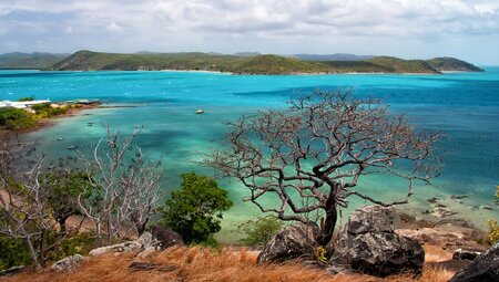 Blue and green ocean water stretches out away from the edge of Thursday Island in the Torres Strait off of northern Queensland