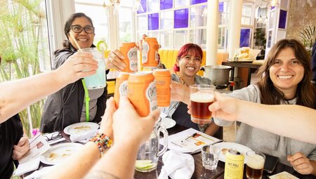 Intrepid group and local guide join a happy cheers in Quetzaltenango Guatemala