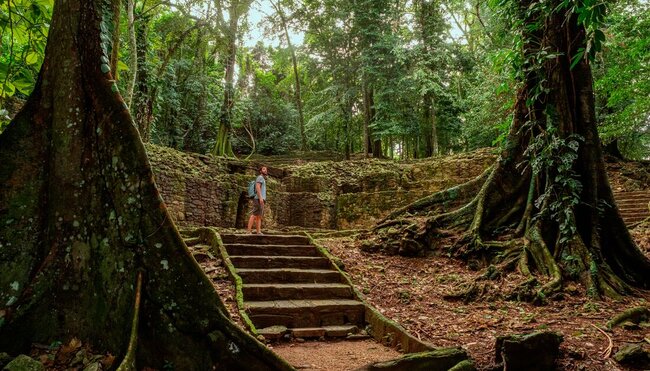 Traveller in Palenque Mayan ruins in the rainforests of Mexico