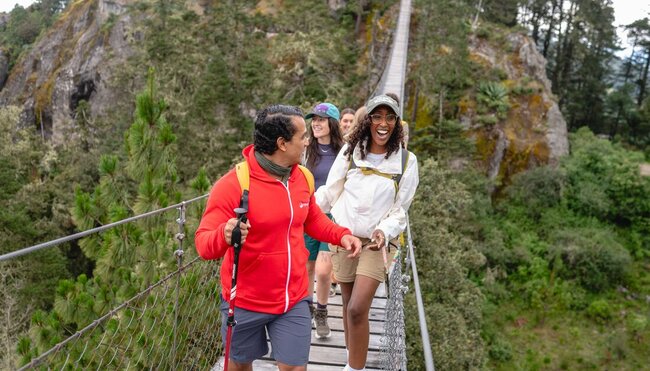 Take in the incredible views on Benito Juarez hanging bridge with Intrepid Travel tour group
