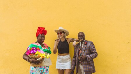 Intrepid traveller laughs and has fun with locals in the streets of Havana