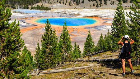 SASY - Person viewing the colourful Grand Prismatic Spring, Yellowstone National Park