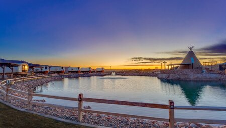 A sunset view of the conestoga wagon glamping tents near Zion National Park, USA