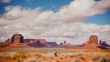 Traveller standing and marvelling at Monument Valley in Utah USA