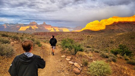 Intrepid travellers hike across a plateau in the depths of the Grand Canyon in Arizona USA