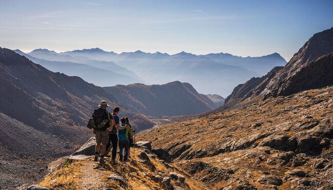 Intrepid travellers in hiking gear and walking sticks trekking through the majesty of Yellowstone National Park