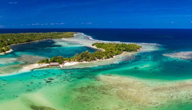 A wide aerial shot of a coastline in Vanuatu