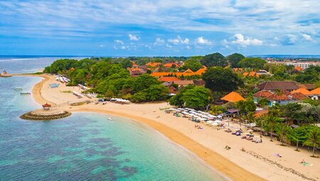 Aerial shot of the coastline along Sanur Beach, located on the southeast coast of Bali, Indonesia