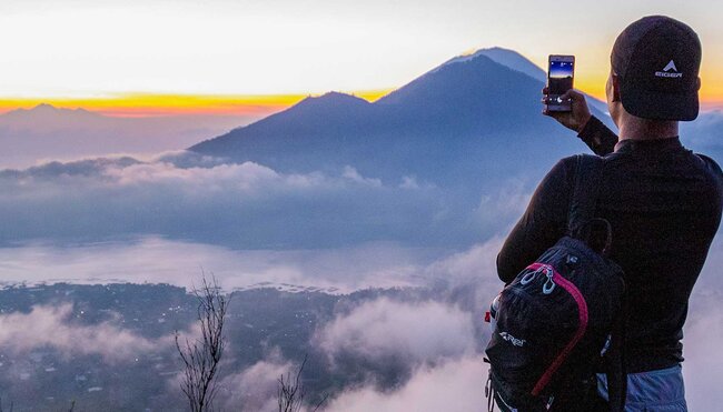 Watch the sunrise from Mt Batur, on the Essential Bali & Gili Islands trip with Intrepid Travel