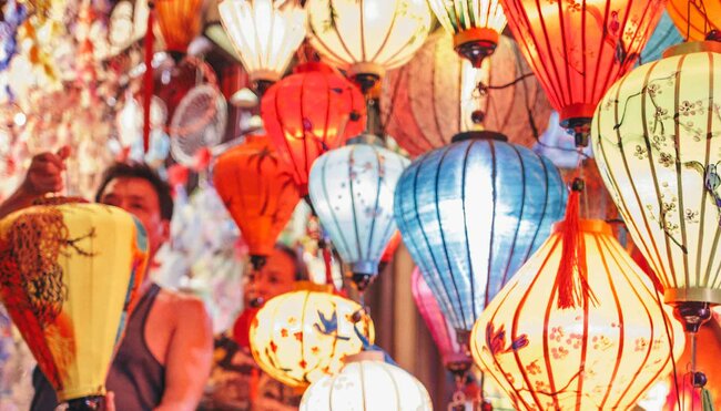 Traveller looks at lanterns at local market in Hoi An, Vietnam