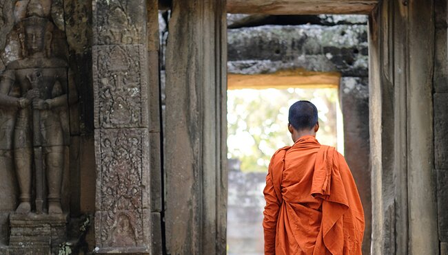 cambodia angkor temple monk walking doorway