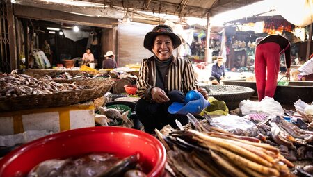 Smiling local fish vendor at market in Siem Reap, Cambodia