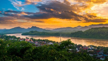 Luang Prabang sunset over Mount Phousi and the Mekong River winding through the Laos countryside