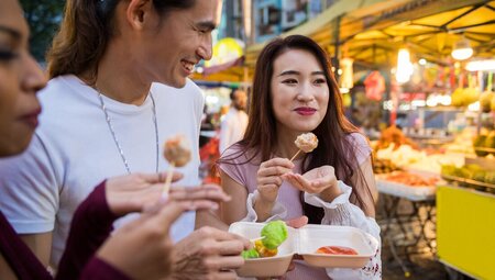 Intrepid travellers stop to enjoy street food in Kuala Lumpur