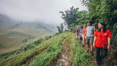 Travellers hike the fields of sapa with their leader